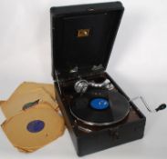 A portable HMV Gramaphone in working order with records.