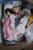 A collection of Bisque headed porcelain dolls, 8 in total, some on stands.