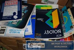 A box of GCSE exam workbooks