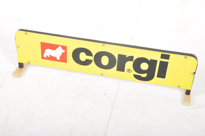 A vintage 1970's / 1980's diecast Corgi shelf top shop display advertising sign. Bold yellow