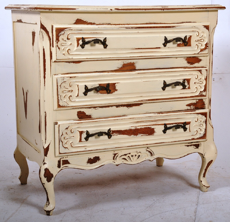 A shabby chic louis IV French chest of drawers. The shaped legs with reeded detailing having an