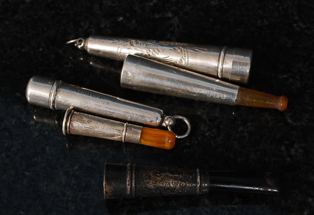 A collection of silver cheroot  / cigarette holders, 2 with hallmarked siver cases