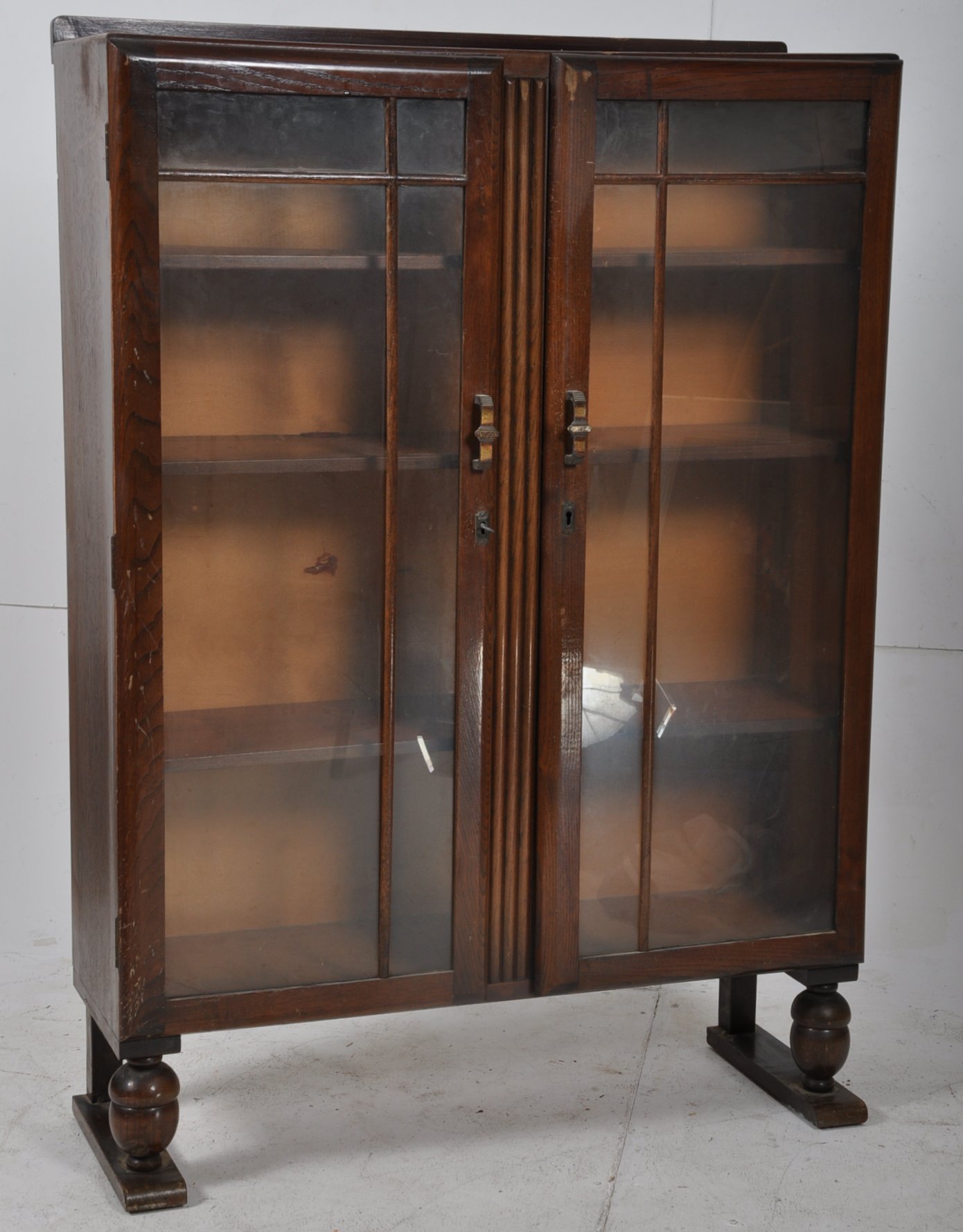 1930's Art Deco bookcase display cabinet. The two glazed doors having shelves within on raised legs.