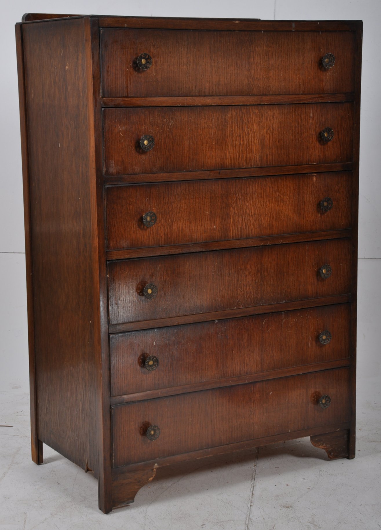 A 1930's Art Deco straight six large chest of drawers. Fret pierced circular handles to each