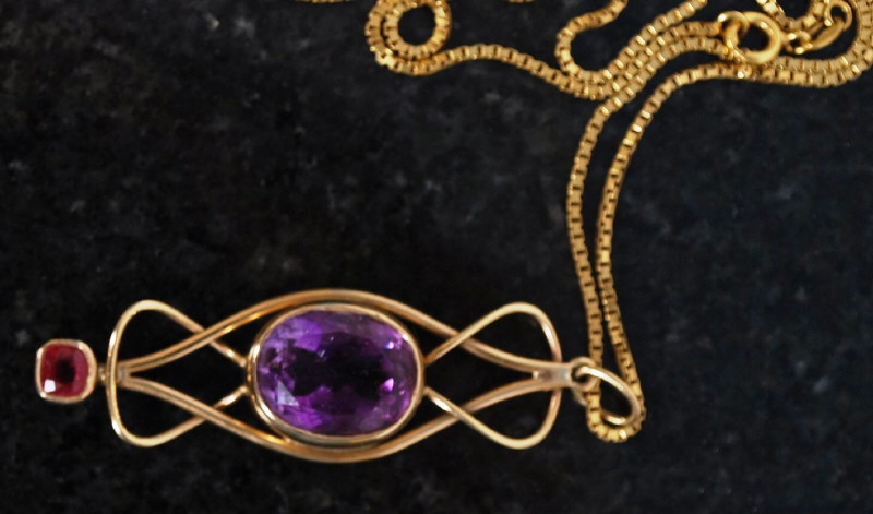 An 18ct gold necklace with good crossover pendant having inset large old european cut Amethyst and