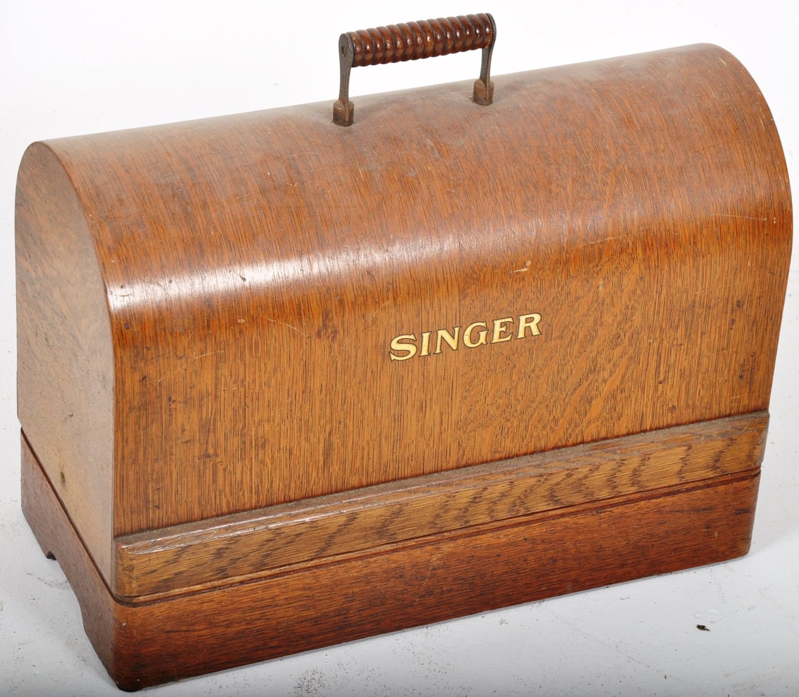 A Victorian oak cased singer sewing machine. Complete with oak dome top carrying case. 31cms High