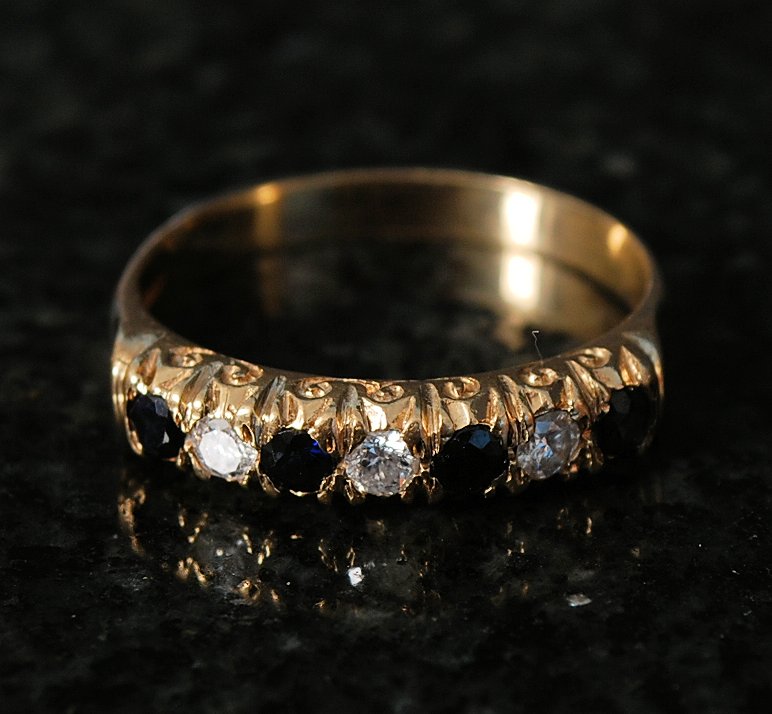 A ladies 9ct gold sapphire and diamond ring. The stones being set to front with 3 sapphire and 3