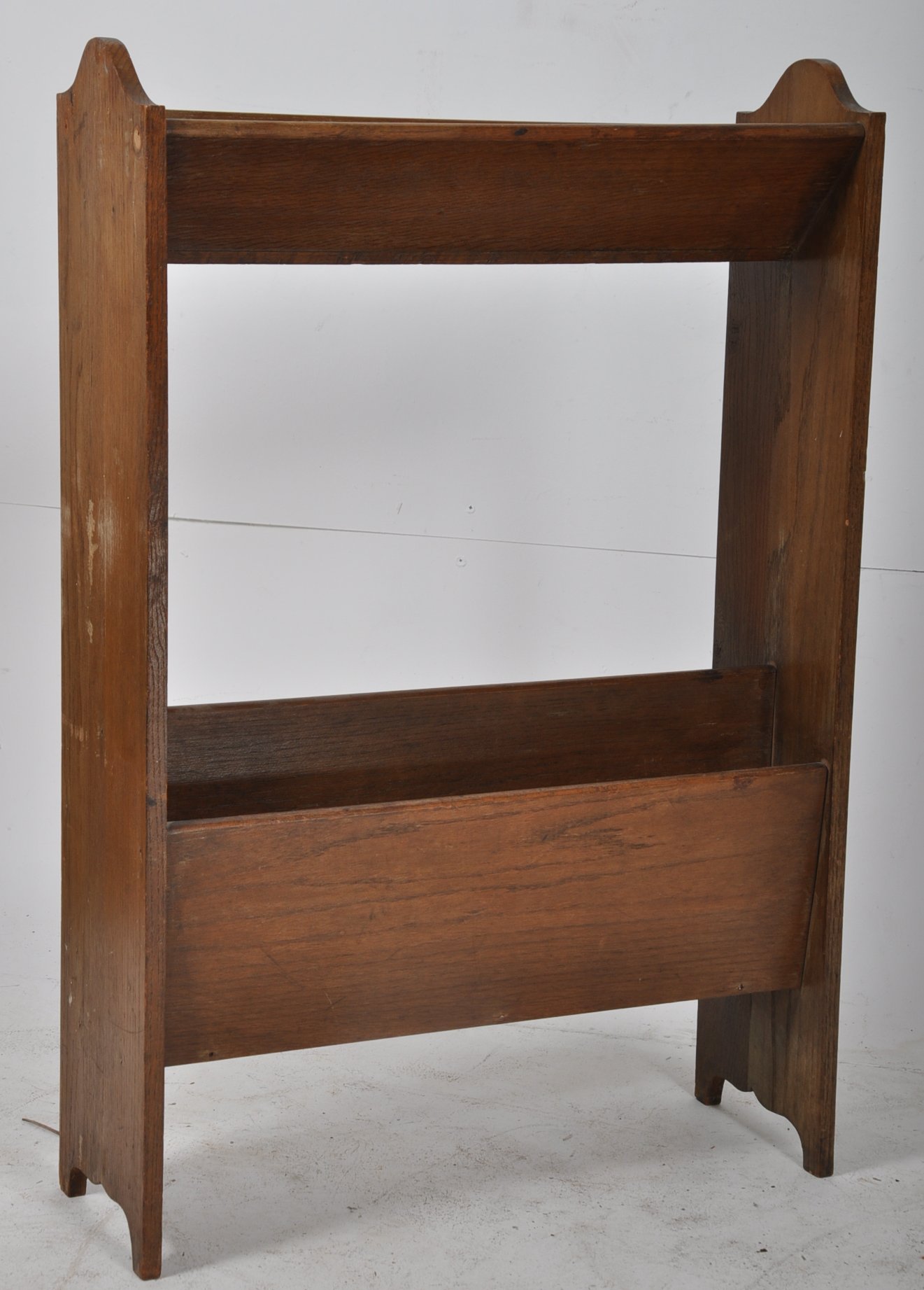 1930's oak book trough / bookcase. The booktroughs set within tall uprights to each side. 90cms high