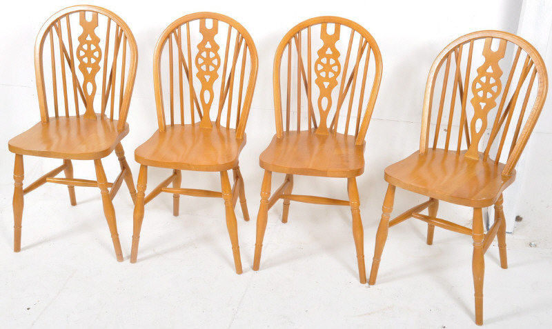 4 antique style beech wood wheel back dining chairs. turned legs united by stretchers supporting