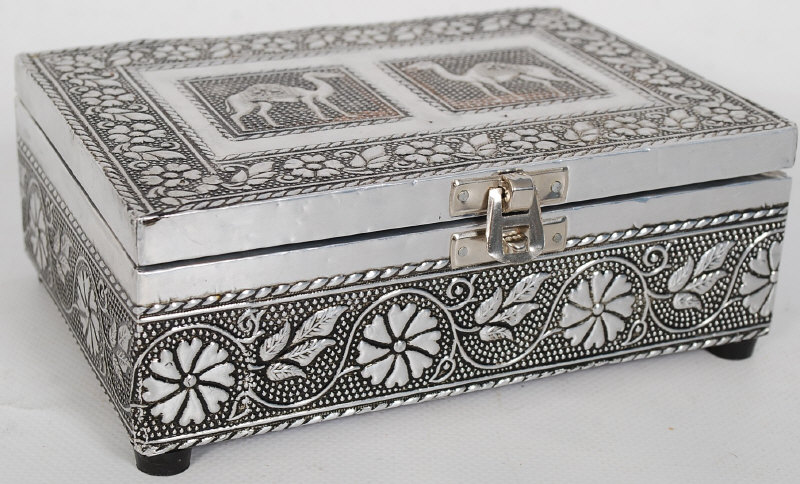 An Indian silver trinket box. The silver raised in relief having decorative camel and foliate border