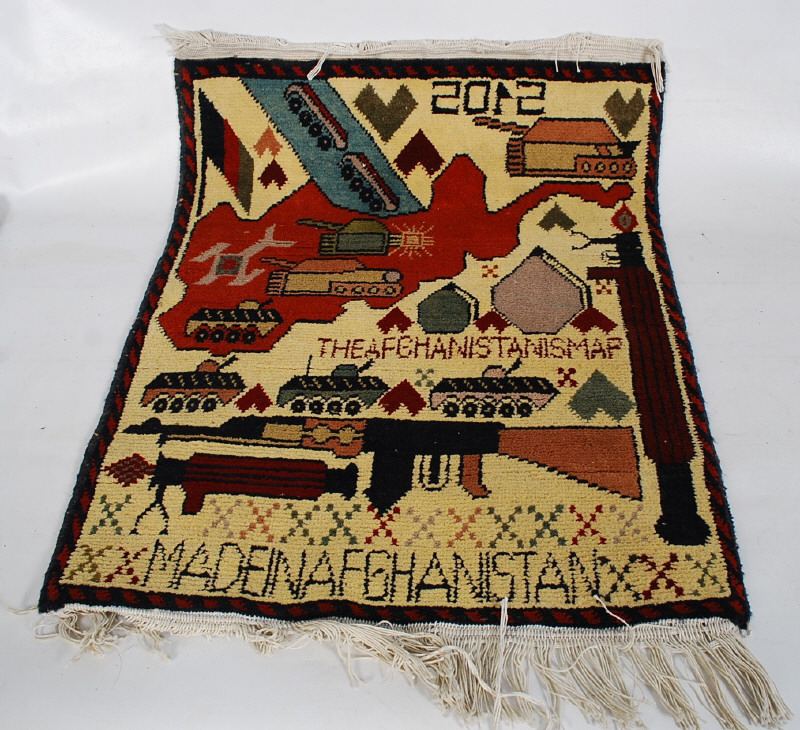 A 2012 decorative Afgan / Afghanistan war rug  / floor runner having military emblems etc with