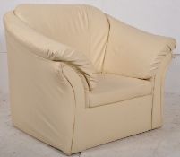 A modern / contemporary cream leather upholstered single armchair. The shaped frame with cream