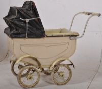 An early 20th century coachbuilt childs pram. The enamel painted body with original wheels having