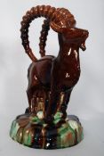 A good 19th century large majolica figurine of an Ibex with arched horns sat on large plinth base.