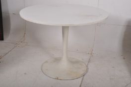 An Arkana Eero Saarinen Tulip style dining table having a circular white laminate top complete with