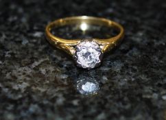 An 18ct gold solitaire and diamond solitaire ring. The centre diamond approximately 25pts, set on a