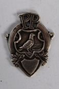 A Pigeon Pictorial hallmarked silver watch fob / medal. Decorative shield design showing pigeon