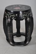 A decorative oriental ebonised chinese stool, with hand painted decoration.