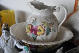 A hand painted wash bowl and jug with floral pattern