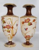 A pair of 19th century Crown Albion Ware baluster vases having decorative hand painted foliates on