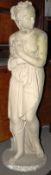 A garden stone statue of a semi-clad maiden clutching her bosom. 116cm tall.