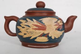 A Chinese 20th century decorative large Yi Xing teapot having decorative bird of paradise