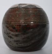 A polished stone and solid silver pot with hallmarks for Henry Hobson & Sons dating to Birmingham