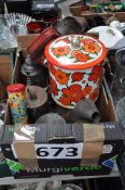 A box of vintage wares to include oil cans, biscuit barrell etc.