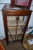 A 1930's Art Deco oak display cabinet. Stood on cabriole legs with astragal glazed door above