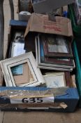 A large box of prints in frames of varying size and age
