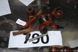 A collection of six vintage pipes together with a pipe cleaner.