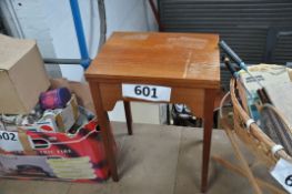 A retro sewing machine table complete with accessories.