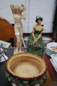 A 1930's plaster figurine of a charming lady carrying flower basket together with another figure.