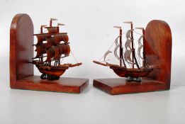 A Pair of wooden bookends with sailing boat decoration.