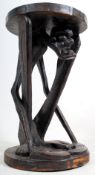 A 20th century large tribal art African Makonde figural table stand. The square plinth base and top