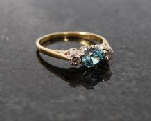 An 18ct yellow gold diamond and aquamarine ring.