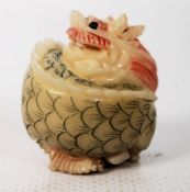 A Chinese oriental carved netsuke in dragon form.