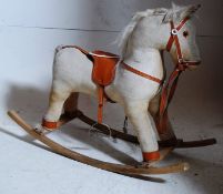 A vintage 1970`s corduroy childs rocking horse on beech wood runners