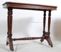 A Victorian solid mahogany writing table / hall table. The turned column supports united by central