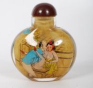 A Chinese glass snuff bottle hand painted with erotic scenes. 6cm tall.