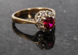 A yellow gold ruby and diamond ring, tested to 9ct.