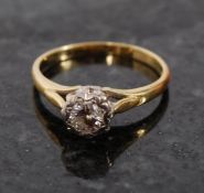 An 18ct gold single stone diamond (40pts approx) ring. The centre diamond stone set on pierced