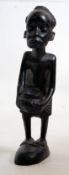 A 20th century carved Ebony wooden Makonde African / Congolese tribal art figure of a man beating