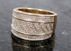 A good 9ct yellow gold set ladies dress ring. The decorative paved oversize ring having geometric