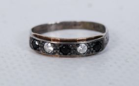 A silver white metal half eternity ring having inset sapphires with diamond stones. The hoop marked