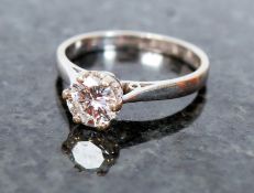 An 18ct single stone diamond white gold ring. The central set brilliant cut diamond in decorative
