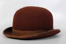 A Victorian Moroccan brown felt bowler hat. Label reading `Morocco Brown Stiffs.` 14cm x 30cm.