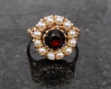 A ladies 9ct gold solitaire seed pearl with brilliant cut ruby stone to centre. 4.3g / Size S