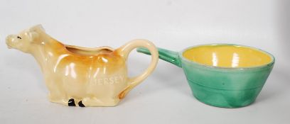 2 pieces of devon pottery to include Crown Devon cow creamer and Braunton Pottery sauce dish