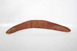 An Aborigne Australian hunting boomerang with inset carved kangaroos. 68cm long.